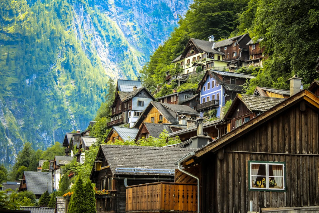 A row of houses set in a mountainous landscape with Pikes Peak visible in the background.