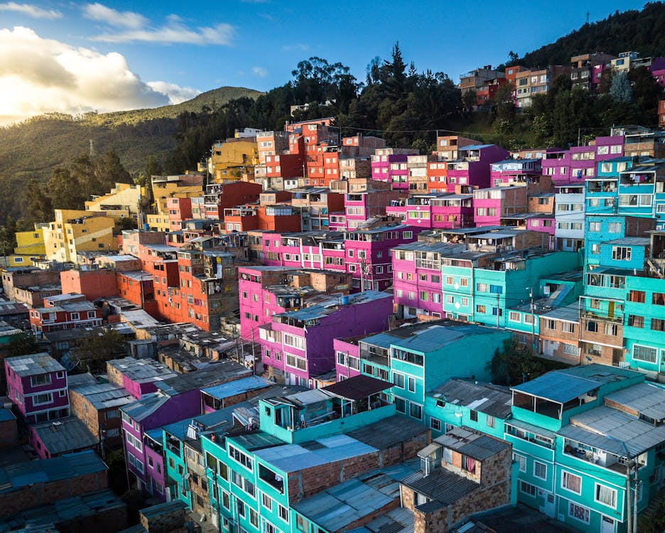 Brightly painted row homes in Bogotá, Colombia, with bold colors like blue, red, and yellow.