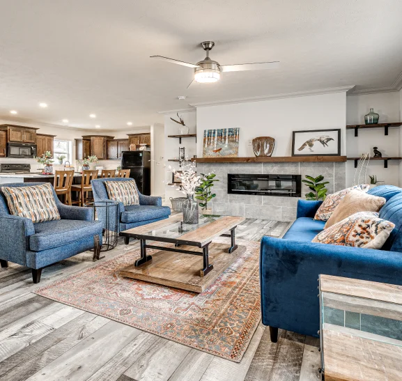 An image of a living room and open kitchen inside a manufactured home in Florissant