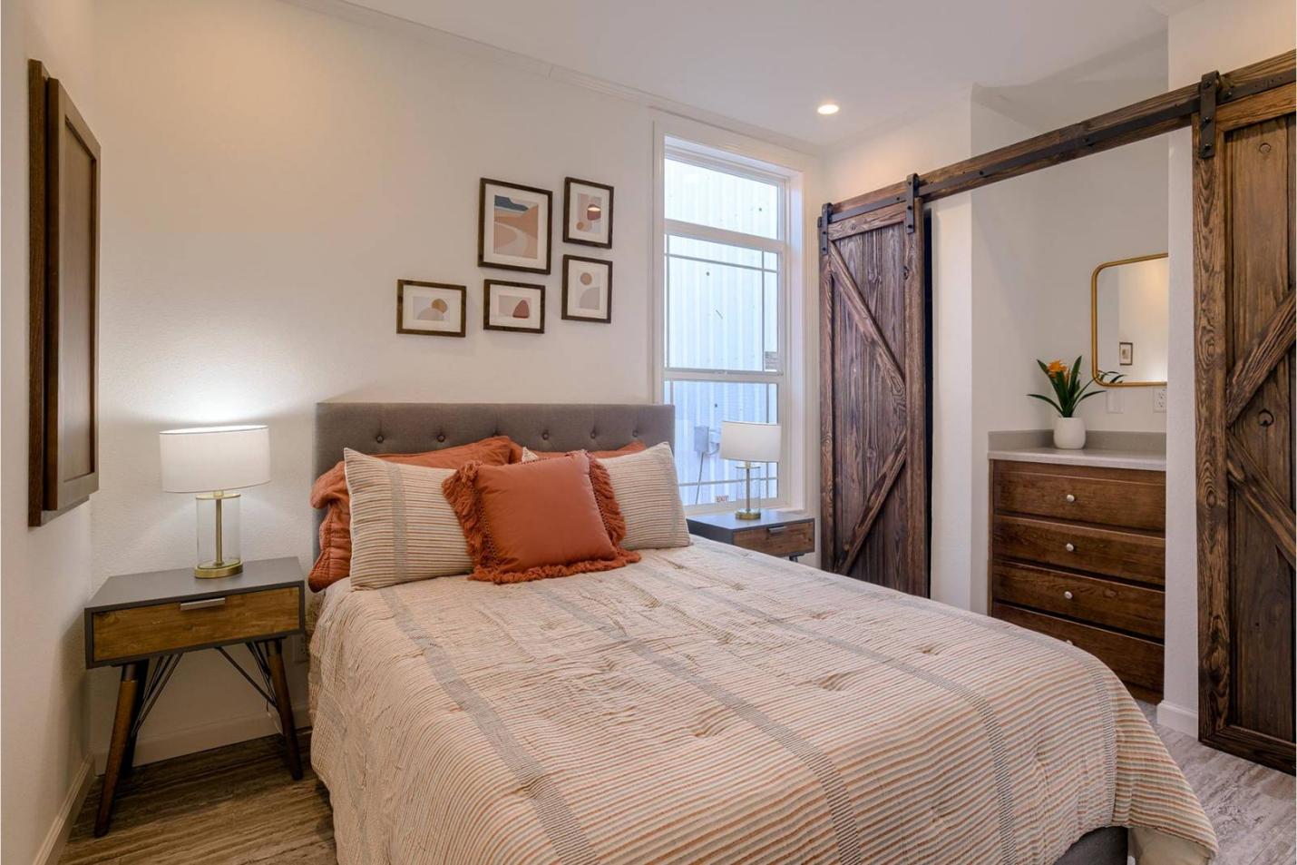 A bright, airy light wood bedroom with lamps
