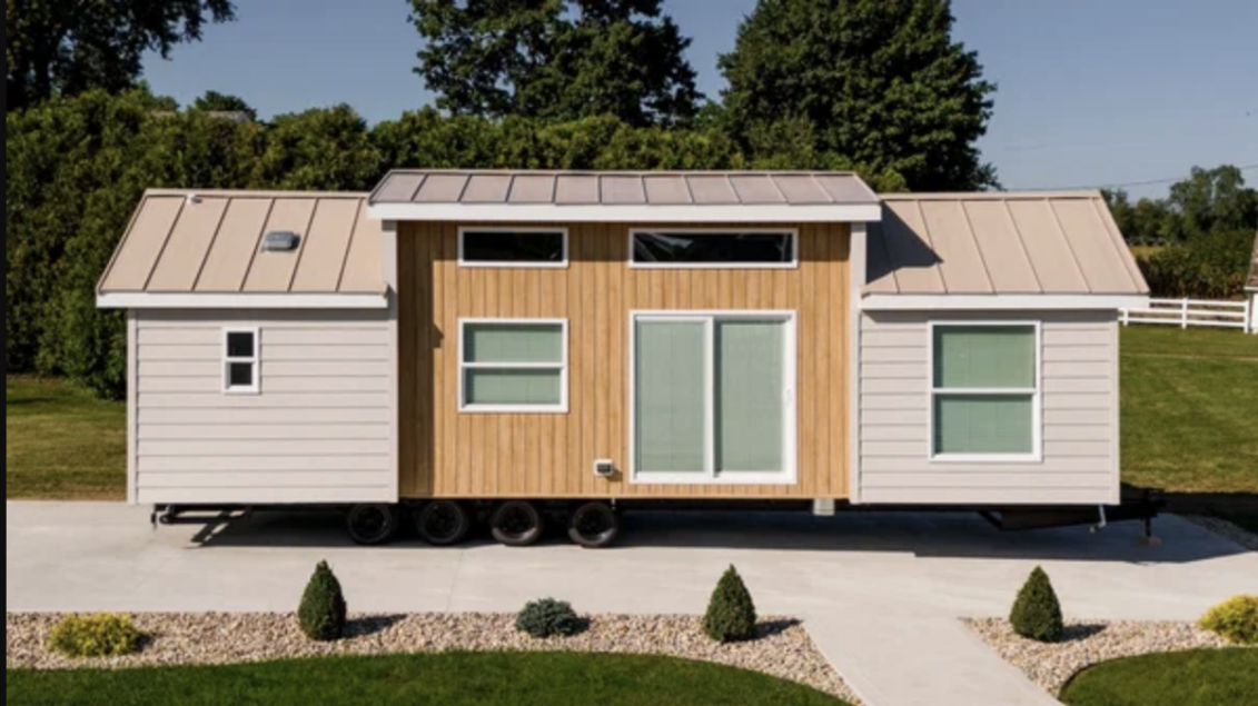 This photo shows a small manufactured home exterior with simple design.